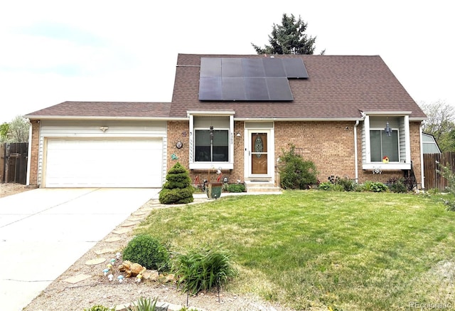 4383 S Eagle Cir, Aurora, CO 80015 - view of front of property with brick siding, a garage, driveway, and roof mounted solar panels