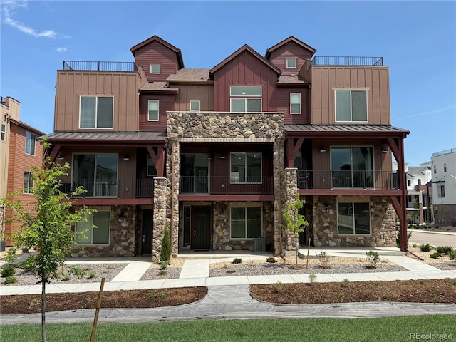 9662 Browns Peak Cir, Littleton, CO 80125 - view of property with stone siding, board and batten siding, and a standing seam roof