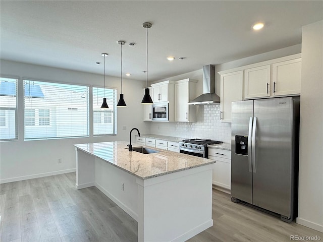 9662 Browns Peak Cir, Littleton, CO 80125 - kitchen featuring appliances with stainless steel finishes, wall chimney range hood, a sink, light wood-type flooring, and recessed lighting