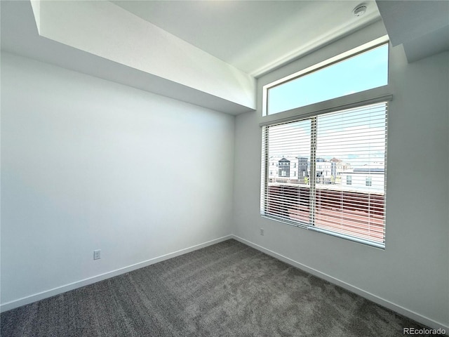 9662 Browns Peak Cir, Littleton, CO 80125 - unfurnished room with dark carpet, baseboards, and a smoke detector
