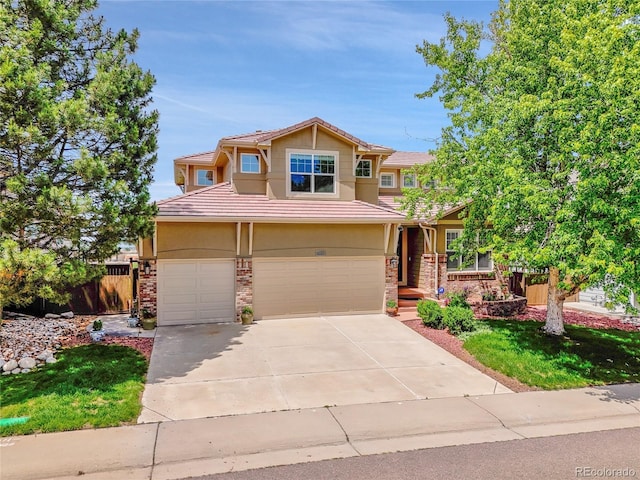 2485 Greensborough Cir, Highlands Ranch, CO 80129 - view of front facade featuring driveway, an attached garage, a tiled roof, and stucco siding