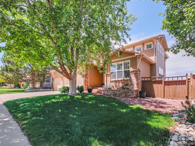 2485 Greensborough Cir, Highlands Ranch, CO 80129 - view of property hidden behind natural elements featuring brick siding and concrete driveway