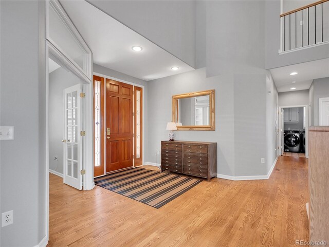 2485 Greensborough Cir, Highlands Ranch, CO 80129 - foyer with washer / clothes dryer, wood finished floors, and recessed lighting