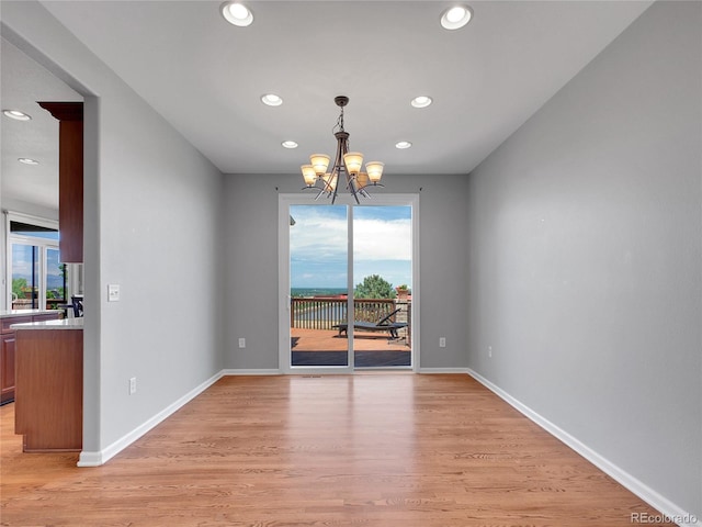 2485 Greensborough Cir, Highlands Ranch, CO 80129 - spare room featuring recessed lighting, a chandelier, and light wood-style floors