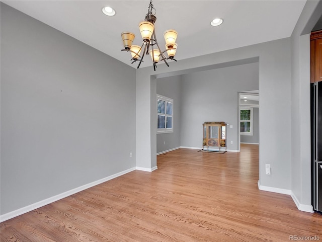 2485 Greensborough Cir, Highlands Ranch, CO 80129 - empty room with a chandelier, light wood-style flooring, and recessed lighting