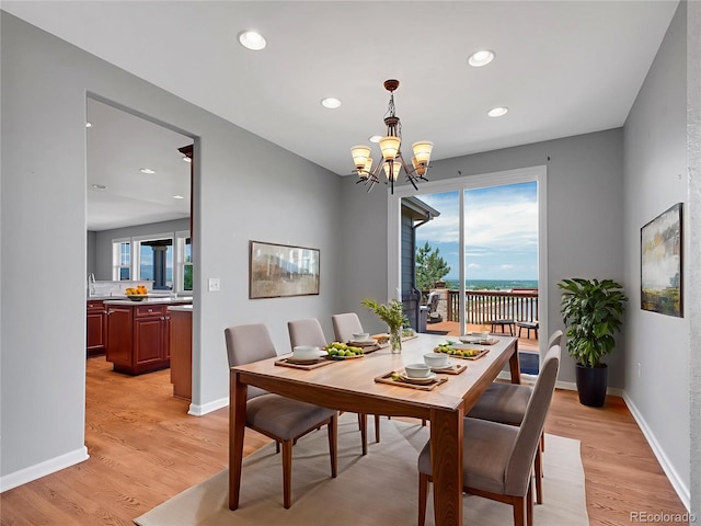 2485 Greensborough Cir, Highlands Ranch, CO 80129 - dining area with light wood-style floors, a chandelier, and recessed lighting