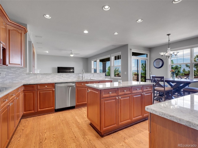 2485 Greensborough Cir, Highlands Ranch, CO 80129 - kitchen with stainless steel dishwasher, light wood finished floors, healthy amount of natural light, ceiling fan, and recessed lighting
