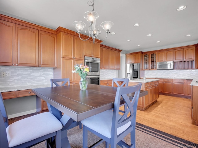 2485 Greensborough Cir, Highlands Ranch, CO 80129 - dining room with a chandelier, recessed lighting, and light wood-style floors
