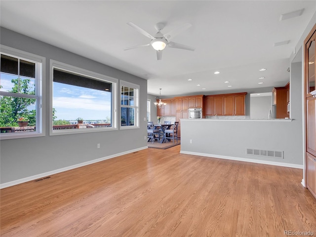 2485 Greensborough Cir, Highlands Ranch, CO 80129 - unfurnished living room with recessed lighting, ceiling fan, a chandelier, and light wood-style floors