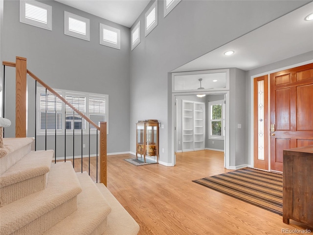 2485 Greensborough Cir, Highlands Ranch, CO 80129 - foyer with stairway, light wood-style floors, recessed lighting, and a high ceiling