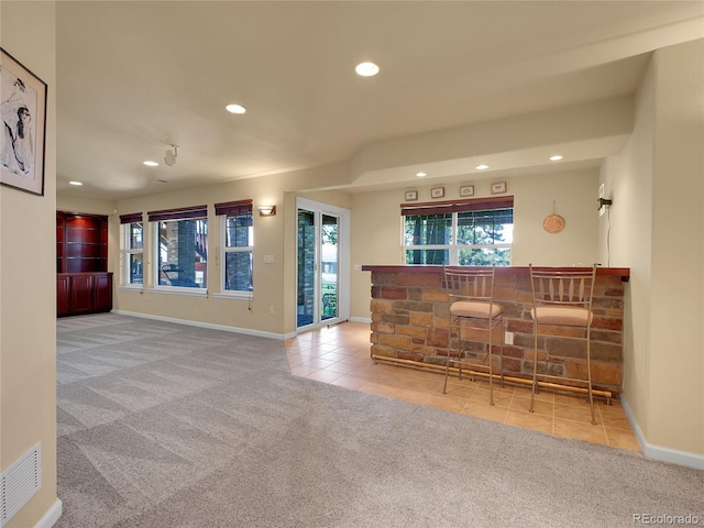 2485 Greensborough Cir, Highlands Ranch, CO 80129 - unfurnished living room with carpet, a bar, healthy amount of natural light, and recessed lighting