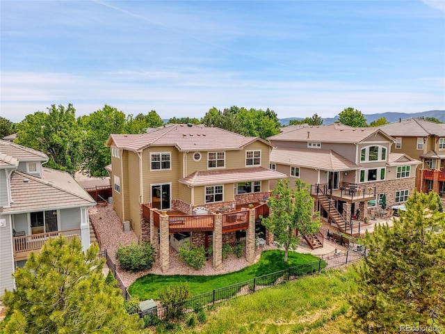 2485 Greensborough Cir, Highlands Ranch, CO 80129 - rear view of house with a fenced backyard, stairway, a residential view, a tile roof, and a deck