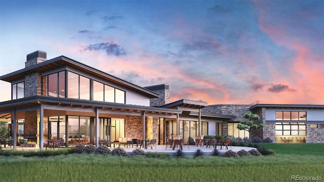 back house at dusk featuring central AC unit, a lawn, and a patio area