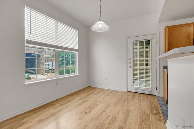 unfurnished dining area with light hardwood / wood-style floors