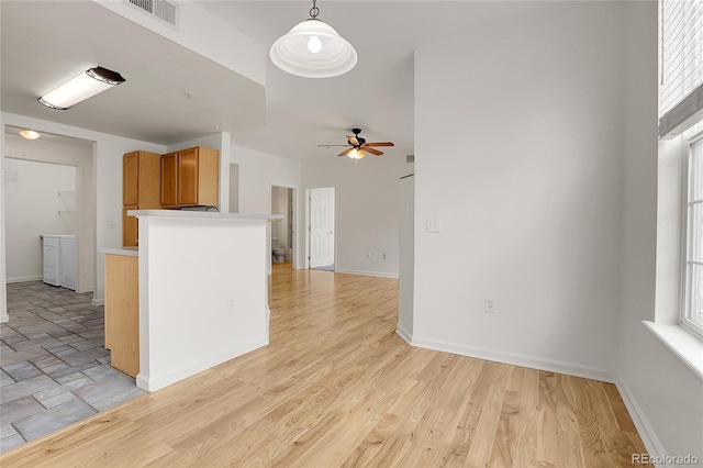 kitchen featuring decorative light fixtures, a healthy amount of sunlight, ceiling fan, and light hardwood / wood-style flooring