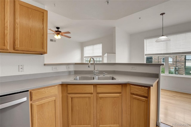 kitchen featuring ceiling fan, lofted ceiling, stainless steel dishwasher, kitchen peninsula, and sink