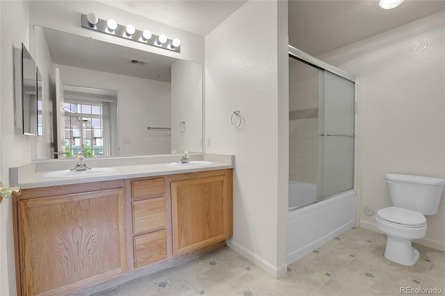 full bathroom with toilet, vanity, and shower / bath combination with glass door