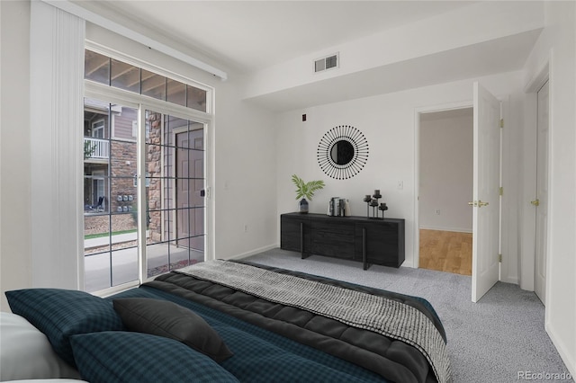 bedroom featuring access to exterior and carpet flooring