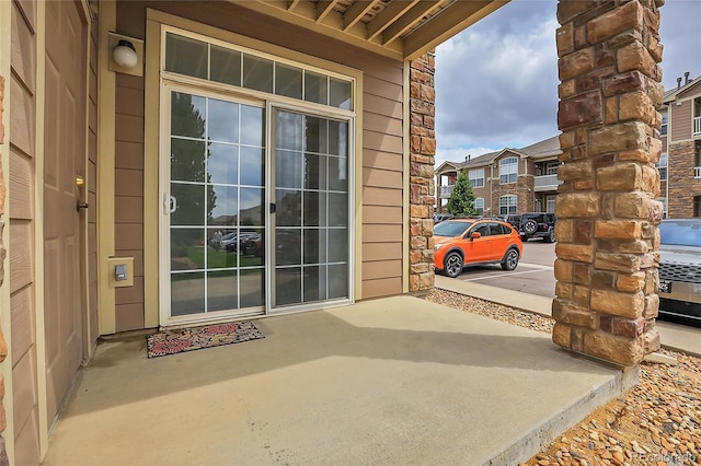 entrance to property featuring a patio