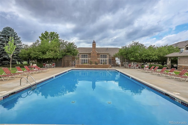 view of swimming pool with a patio area