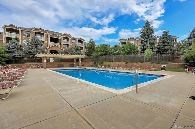 view of swimming pool with a pergola and a patio