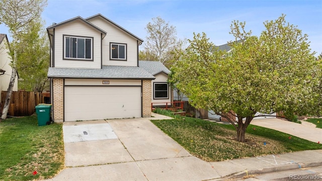 5849 Chokecherry Dr, Colorado Springs, CO 80919 - traditional home with fence, an attached garage, roof with shingles, and brick siding