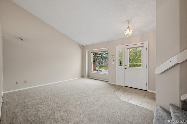 5849 Chokecherry Dr, Colorado Springs, CO 80919 - carpeted foyer entrance featuring stairway, baseboards, tile patterned flooring, and vaulted ceiling