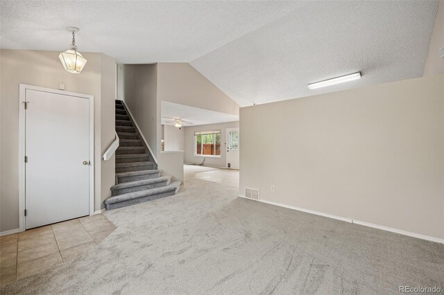5849 Chokecherry Dr, Colorado Springs, CO 80919 - interior space with visible vents, stairs, baseboards, a textured ceiling, and vaulted ceiling