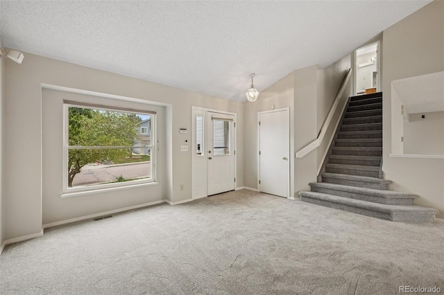 5849 Chokecherry Dr, Colorado Springs, CO 80919 - carpeted entrance foyer with stairway, baseboards, and visible vents