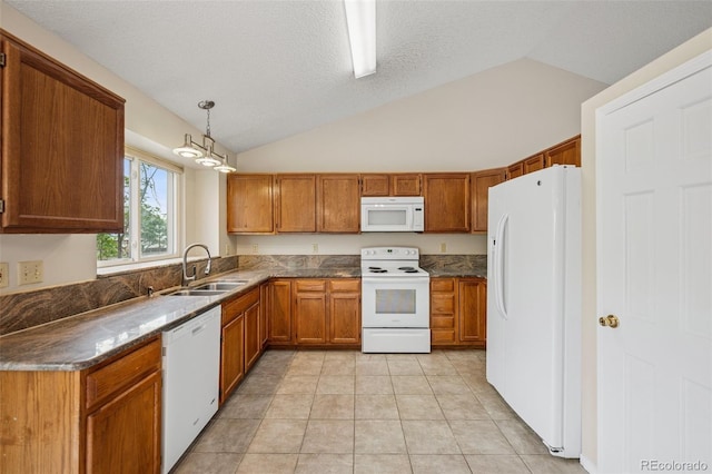 5849 Chokecherry Dr, Colorado Springs, CO 80919 - kitchen featuring a sink, brown cabinets, vaulted ceiling, and white appliances