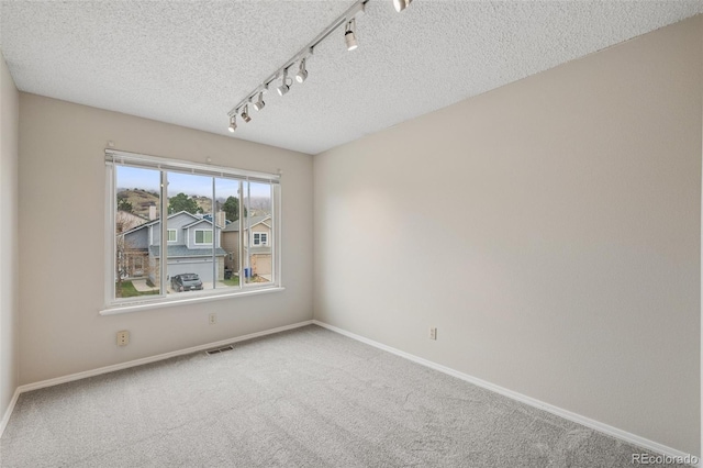 5849 Chokecherry Dr, Colorado Springs, CO 80919 - unfurnished room with carpet floors, a textured ceiling, and visible vents
