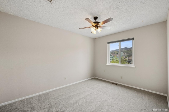 5849 Chokecherry Dr, Colorado Springs, CO 80919 - unfurnished room with visible vents, baseboards, a textured ceiling, a ceiling fan, and carpet