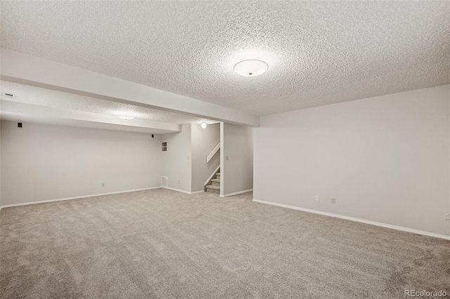 5849 Chokecherry Dr, Colorado Springs, CO 80919 - finished basement with carpet flooring, a textured ceiling, baseboards, and stairs