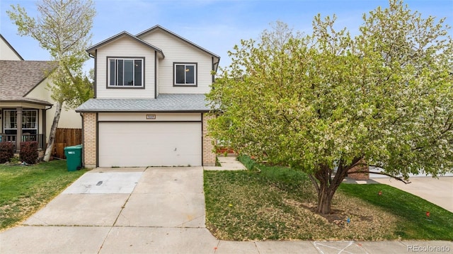 5849 Chokecherry Dr, Colorado Springs, CO 80919 - traditional-style home with a garage, fence, brick siding, a shingled roof, and driveway