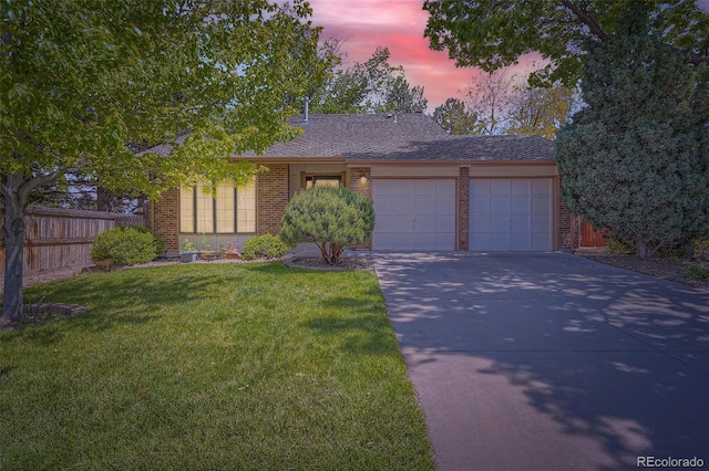 8144 W 81st Dr, Arvada, CO 80005 - view of front of house with brick siding, an attached garage, and driveway