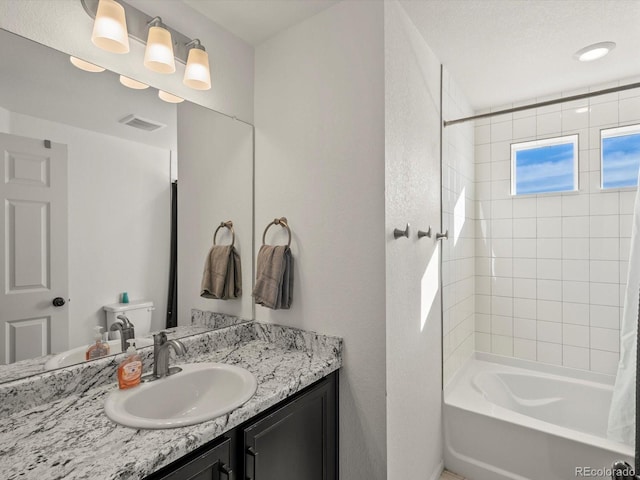 bathroom featuring vanity and tiled shower / bath combo