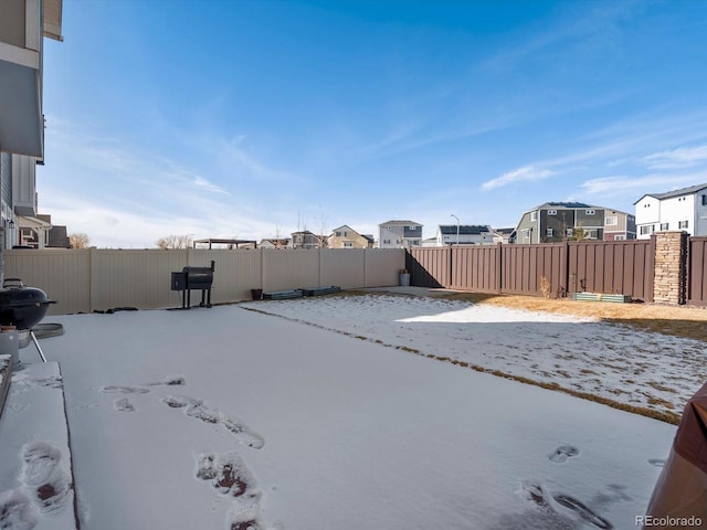 view of yard layered in snow