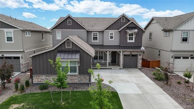 craftsman house featuring covered porch, a front yard, and a garage