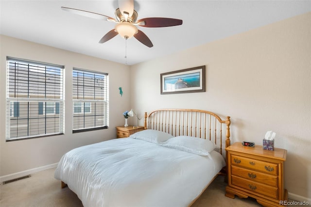 bedroom featuring baseboards, ceiling fan, carpet, and visible vents