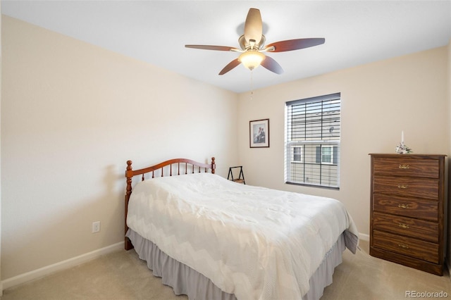 bedroom with baseboards, light carpet, and a ceiling fan