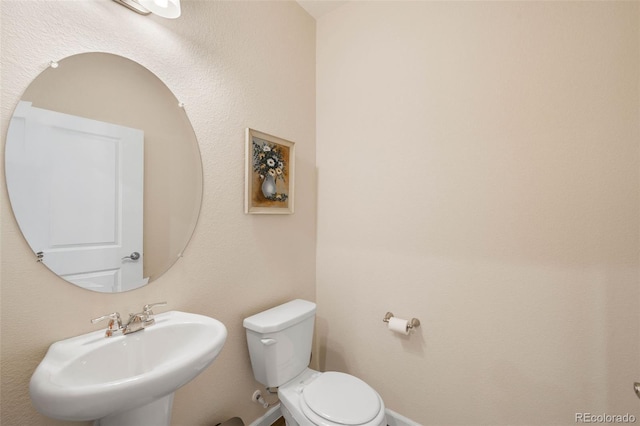 bathroom featuring a sink and toilet