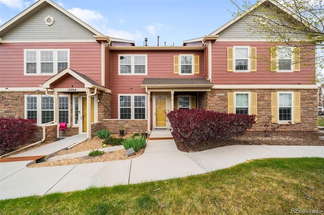 townhome / multi-family property with stone siding