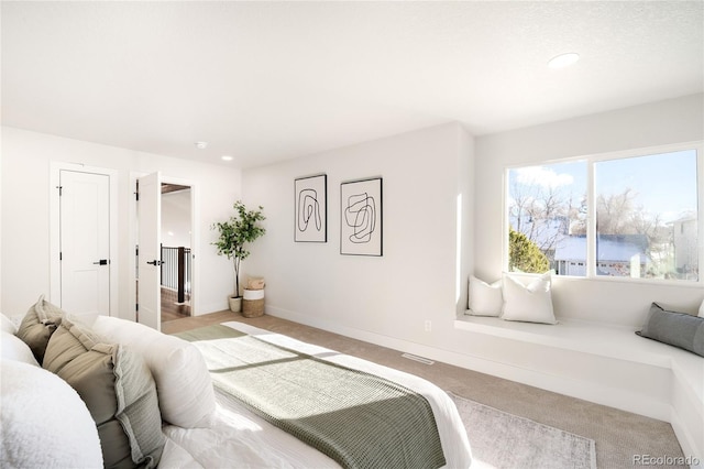 bedroom with light colored carpet