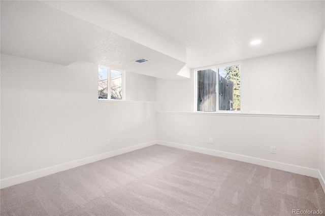 interior space with carpet floors and a textured ceiling