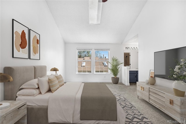 carpeted bedroom with ensuite bathroom and high vaulted ceiling