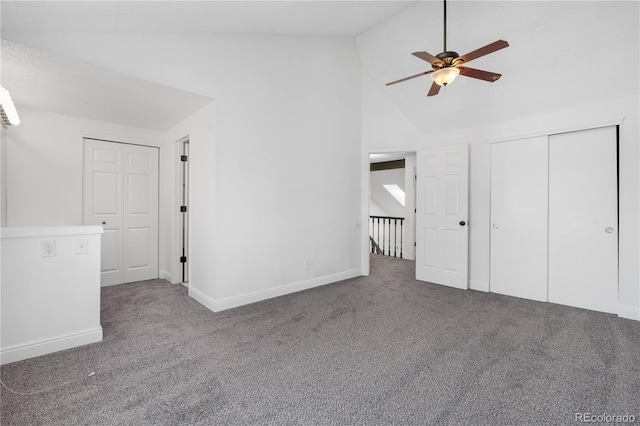 interior space with carpet, baseboards, a ceiling fan, and high vaulted ceiling