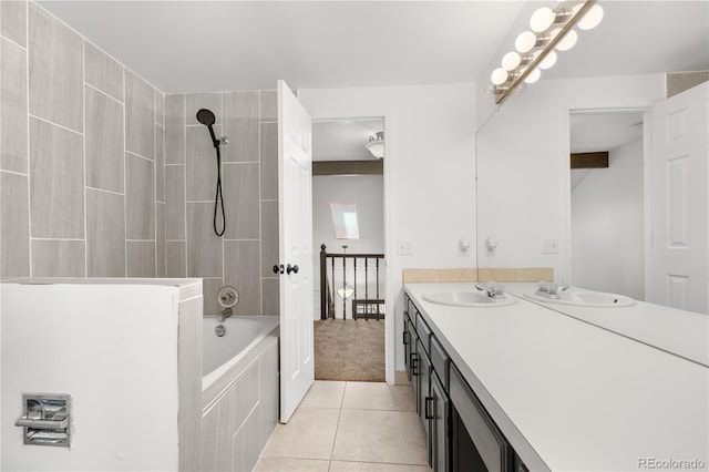 full bath with tile patterned floors, tiled shower / bath, and vanity