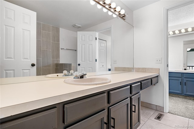 bathroom featuring tile patterned flooring, visible vents, and vanity