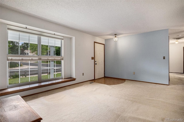 523 E Long Ct, Littleton, CO 80122 - carpeted spare room featuring a textured ceiling and baseboards