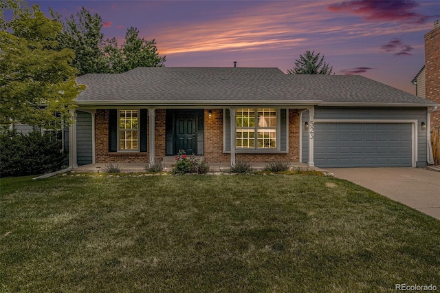523 E Long Ct, Littleton, CO 80122 - ranch-style home featuring an attached garage, driveway, brick siding, and a yard